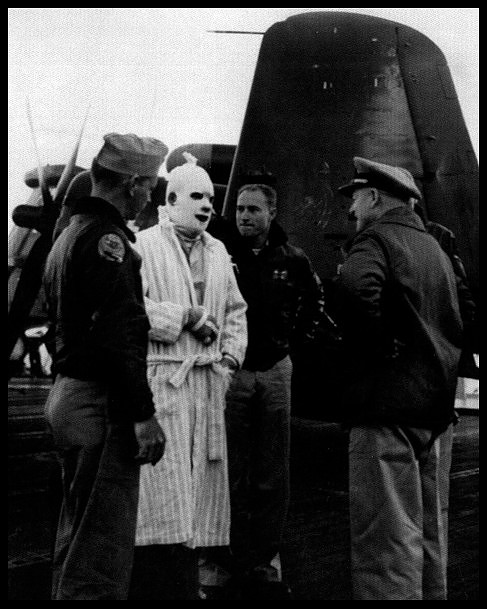 A rescued and bandaged LTJG John Lavra, USN.